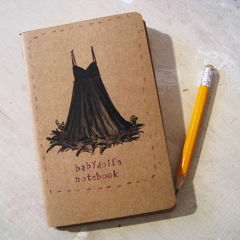 A little black babydoll dress adorns the cover of this little moleskine notebook. hand illustrated by brighton artist Linda Boucher.