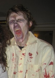 male zombie with blonde hair screaming at camera