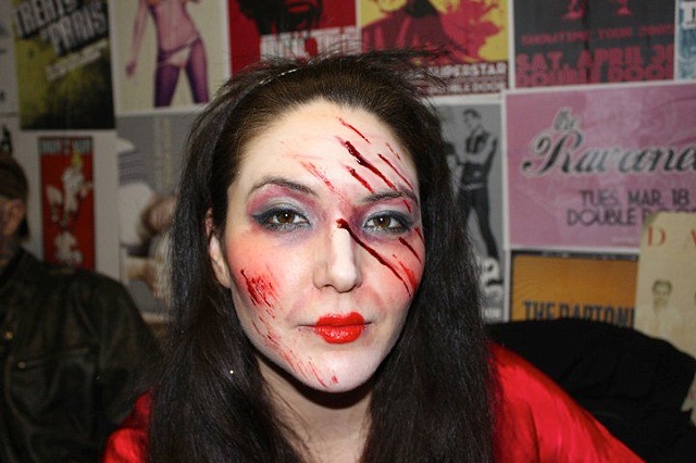 girl zombie with scratches across her face, gore, blood