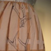 fenced in an apron (white). (detail)