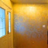 Gold leaf circle motif over silver on foyer wall.