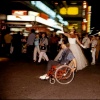 Man Passing Patina in Wheelchair