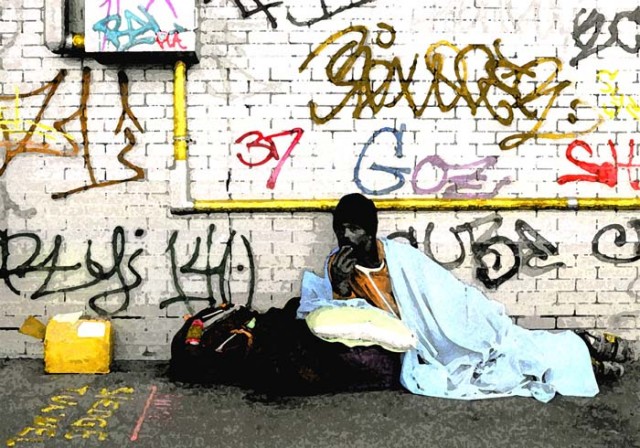 Man with blue blanket and graffitti