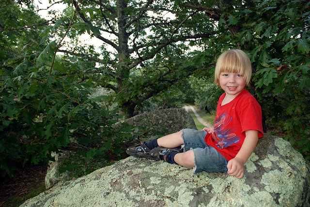 boy on large rock