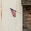 Flag On The Side Of An Old Warehouse