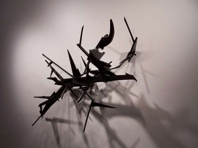 Metal logo sculpture by artist Owen Rundquist