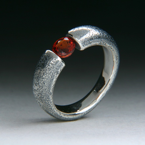 Sterling silver tension set garnet ring