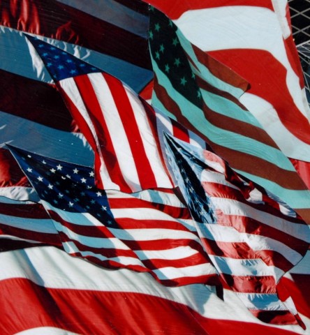 Photo collage by John Schuh featuring the American Flag and downtown Seattle Public Library.