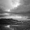 Lone surfer and rain at sea
