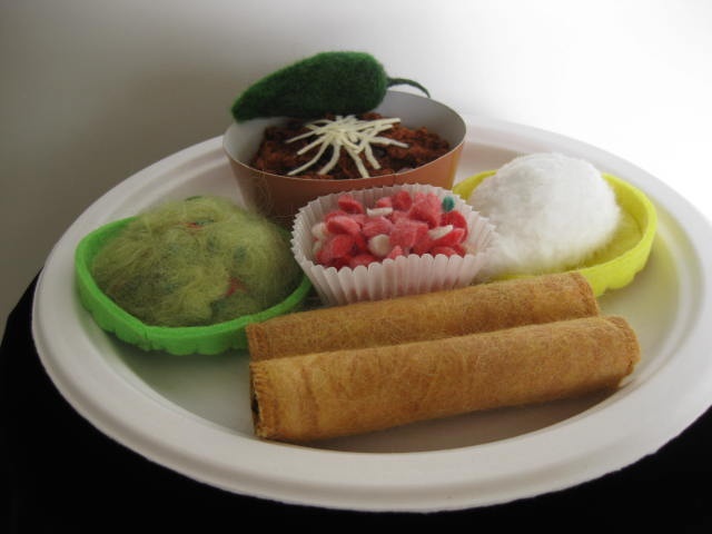 "Tex-Mex Combo Plate #7" is a felted mixed media piece of contemporary fiber art by Linda Thiemann. 