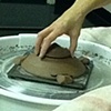 Fitting the lid into the top.