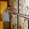 Matt Dowdy installing paintings