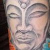 Buddha with flowers tattoo