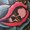 wing and rose morph. neck tattoo