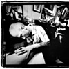 Tommy Helm tattooing my thigh