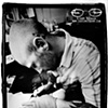 Tommy Helm tattooing my thigh