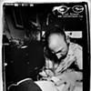 Tommy Helm tattooing my thigh