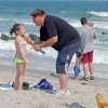 Atlantic City swimmers:  sun-lotion application