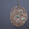 Flat pendant with emeralds set in 14kt bezels.