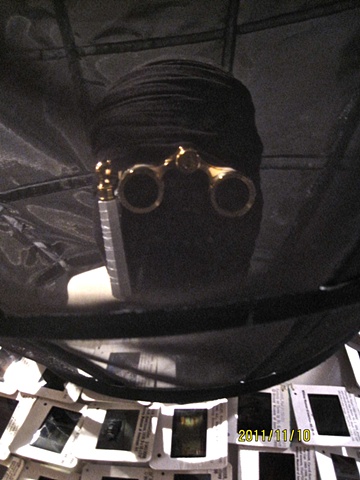 Opera glasses mask. 
Part of slide robe and satellite installation 
