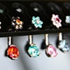 Curved Barbells with Prong Set Faceted Gems and Flowers