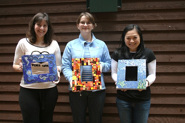 Students with finished mosaic frames