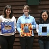 Students with finished mosaic frames