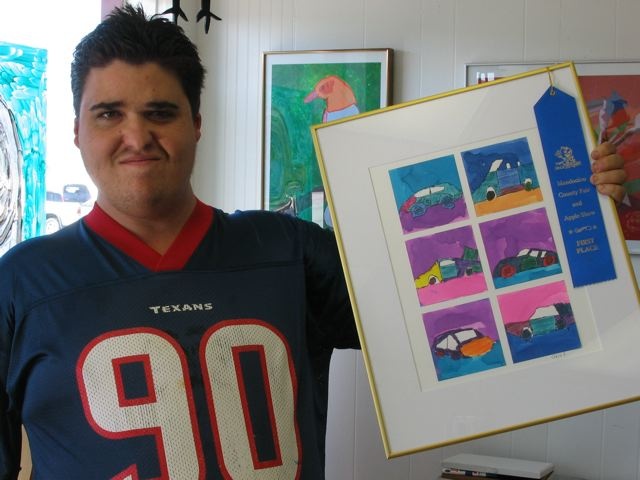 Chris Freitas with a blue ribbon for "Little Cars"