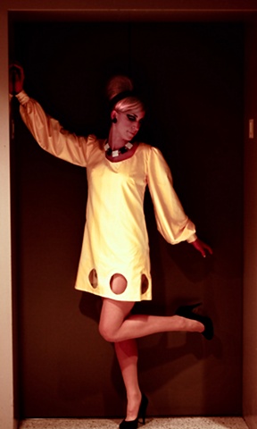 Yellow cotton 60's inspired dress with clear vinyl circles at hemline. 