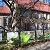 Digitally-printed banners installed on the front fence of the Old Stone House