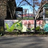 Digitally-printed banners installed on the front fence of the Old Stone House