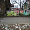 Digitally-printed banners installed on the front fence of the Old Stone House