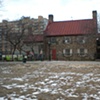 Digitally-printed banners installed on the front fence of the Old Stone House