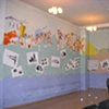 View from back of the room, with photos of the mural process added to "blank" book pages