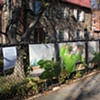 Digitally-printed banners installed on the front fence of the Old Stone House