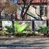 Digitally-printed banners installed on the front fence of the Old Stone House