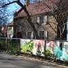 Digitally-printed banners installed on the front fence of the Old Stone House