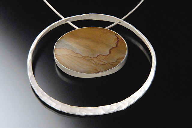 The setting of this stone was constructed to enable its movement on the chain