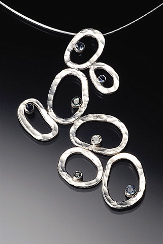 Forged and fabricated, this piece highlights the variety of Sapphire colors.