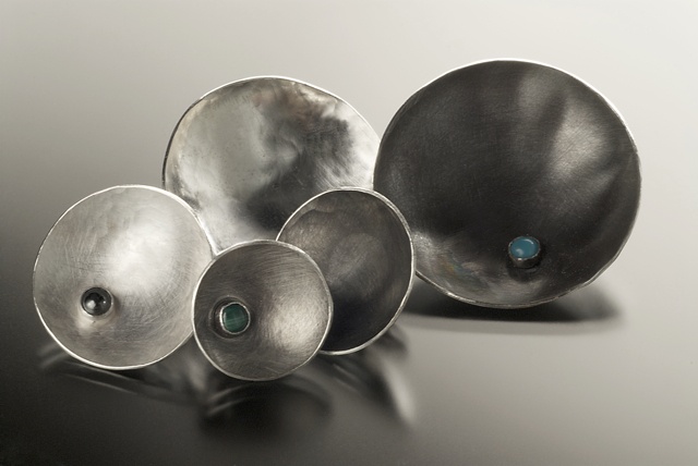 Forged and fabricated with semi-precious cabochon cut stones.