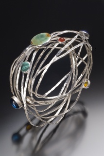 Forged and fabricated sterling silver with various semi-precious gemstones, this bracelet are available with faceted and cabochon cut stones as well as a variety of finishes.