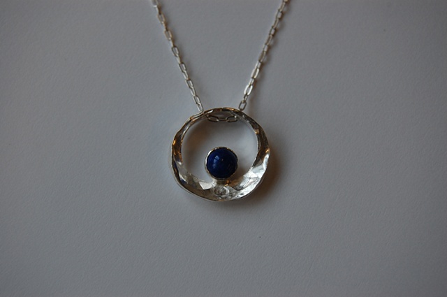 Forged and fabricated, this is available in 14k gold or sterling silver with cabochon or faceted cut stones.
