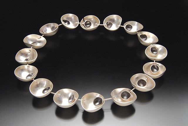 Forged and fabricated sterling silver with patina. This piece moves with you.