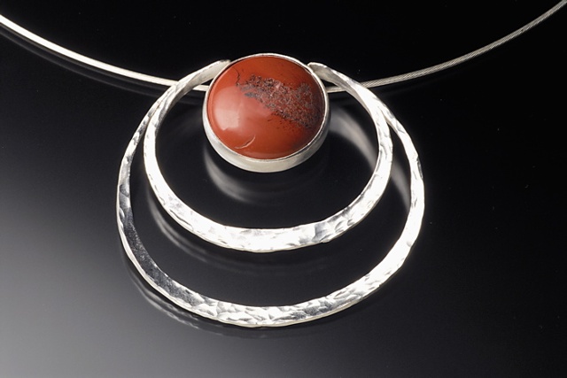 Forged and fabricated with a cabochon cut stone.
