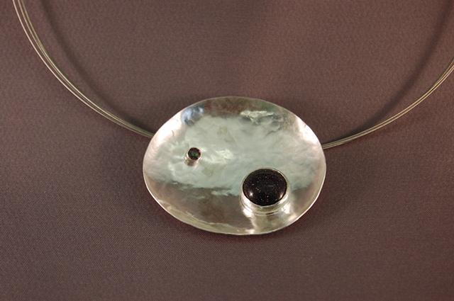 Formed and fabricated, this piece functions as a brooch and pendant.