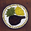 A meat entree with two color-coordinated vegetable sides.