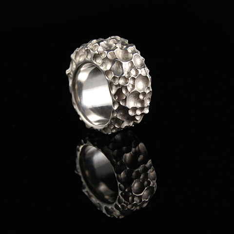 Chunky textured Sterling Silver ring. Created from solid sterling silver, it features textured, crater like recesses to create its intriguing details.