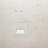 Plate made to blend with stone wall
