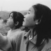Two Girls Flying a Kite