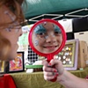 A Winter Wonderland Princess Smiles as she looks in the mirror - Image via uptownmessenger.com